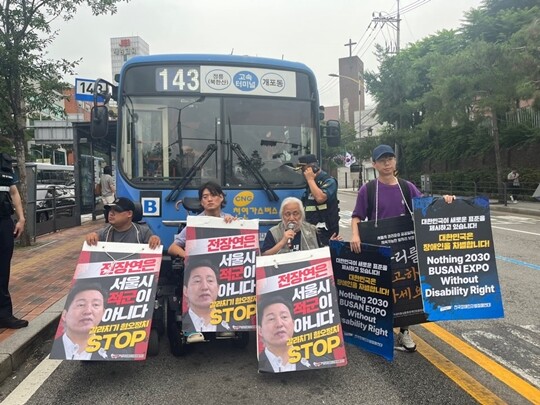 전국장애인차별철폐연대가 13일 오전 서울 종로구 혜화동로터리 중앙버스전용차로를 약 10분간 가로막고 기습시위를 벌였다. 사진=연합뉴스