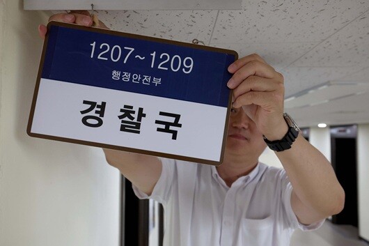 행정안전부가 대통령령인 '행정안전부와 그 소속기관 직제'를 시행해 경찰국이 폐지된 2025년 8월 26일 서울 종로구 정부서울청사 내 경찰국 사무실에서 직원이 경찰국 간판을 제거하고 있다. 사진=임준선 기자